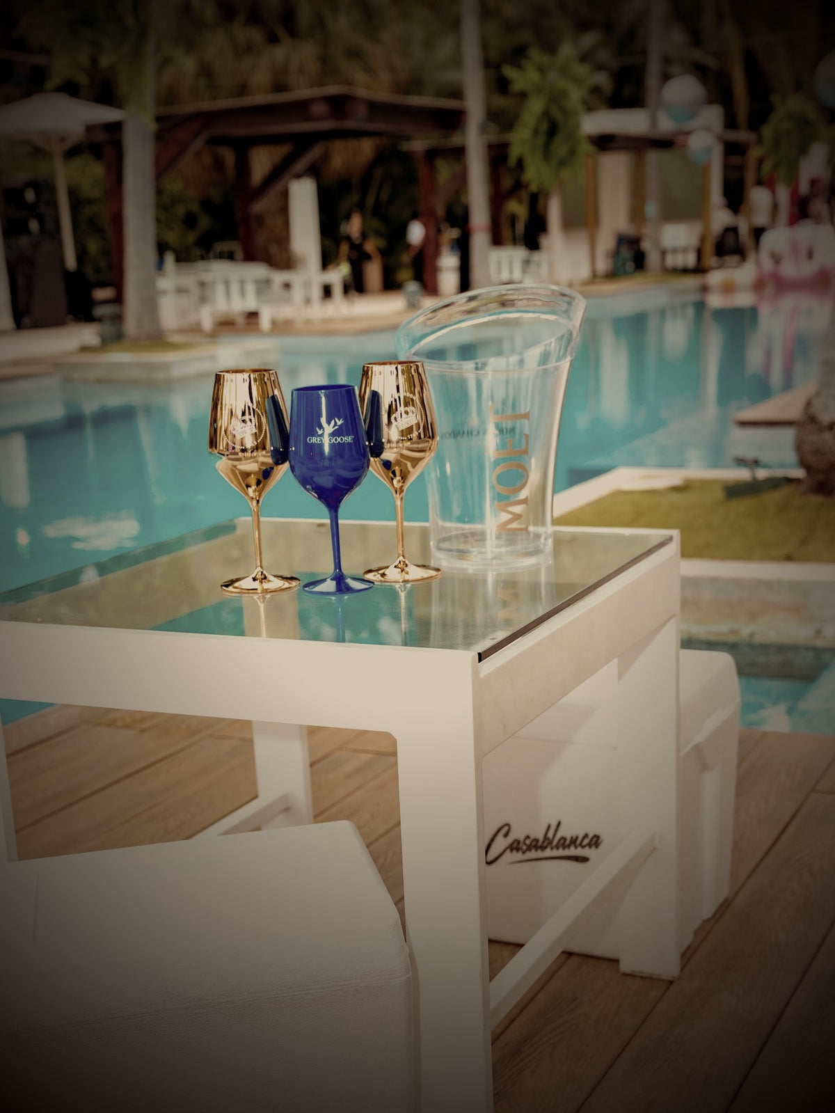 Casablanca lounge table with gold glasses and an ice bucket in warm evening light